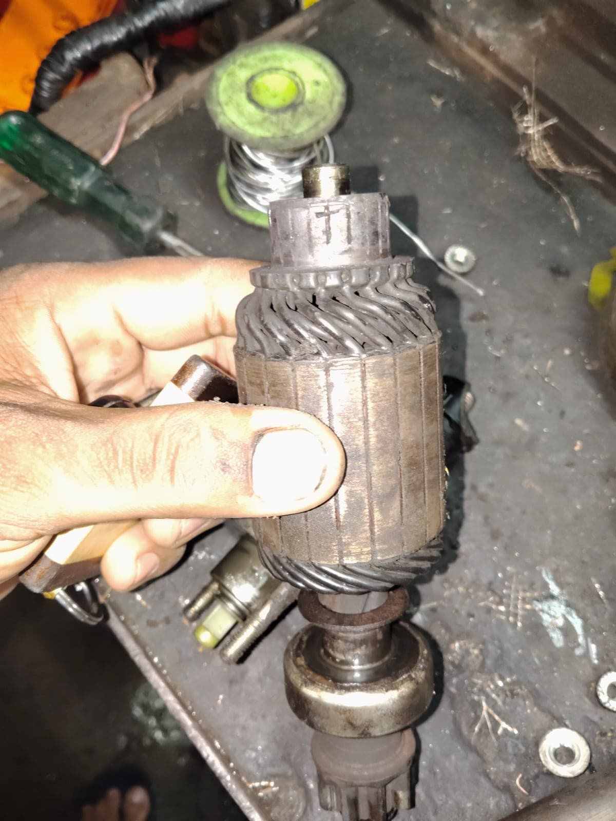 Starter motor armature being inspected during repair at Siddhi Automobiles